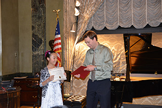  Tianran Song, piano student of Yevgeny Morozov, holding her certificate. 