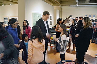  Concert series at the The Zimmerli Art Museum: professional performer and piano teacher, Yevgeny is surrounded by his students after the concert. 